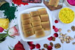 Mysore Pak pieces neatly arranged on a silver platter.