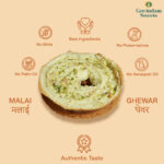 Close-up of Malai Ghewar topped with thick rabri and chopped dry fruits