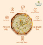 Close-up of Paneer Ghewar topped with crumbled paneer and dry fruits