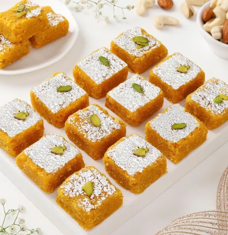 Moong Dal Barfi – Traditional Sweet Made with Pure Ghee and Yellow Lentils Close-up of Moong Dal Barfi with golden color and almond-pistachio topping